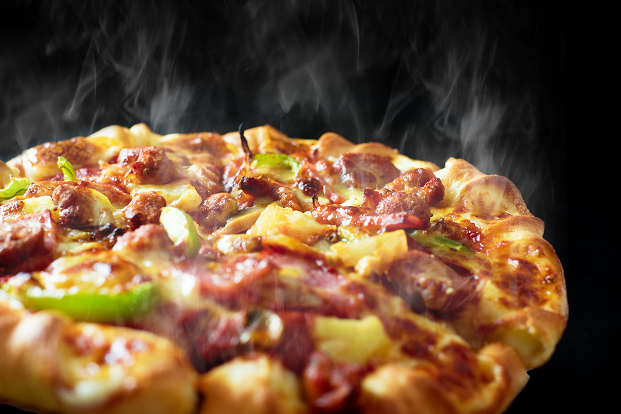 Pizza with cheese, ham, bacon and pepperoni