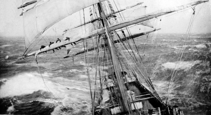 Four sailors on the main yardarm