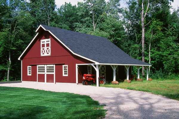 Red barn with a parked tractor