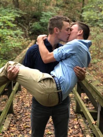 Two young men kissing