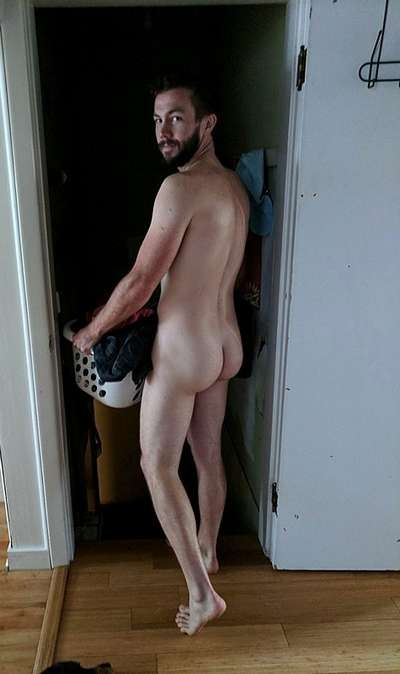 Young man carrying a laundry basket