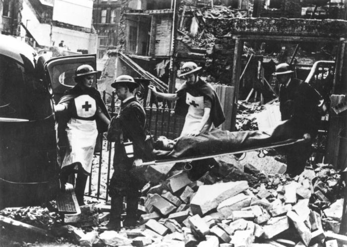 A stretcher party loads a casualty into an ambulance