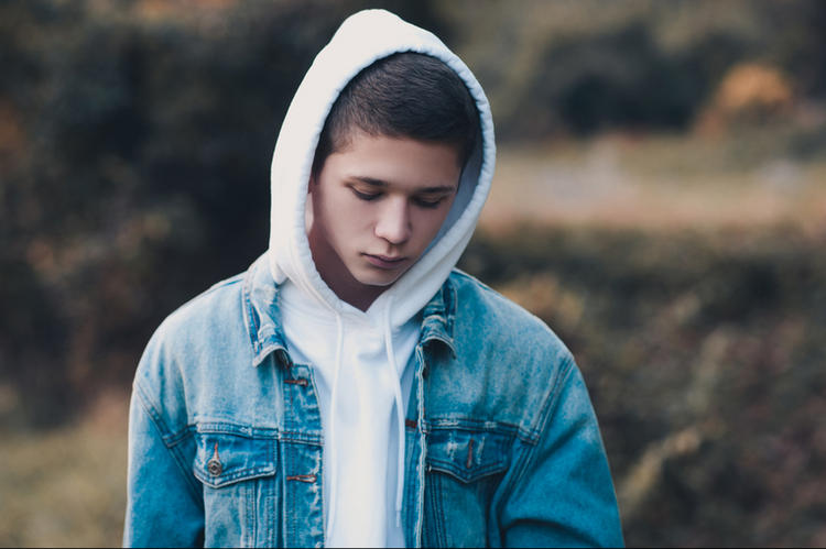 Sad-looking teenage boy