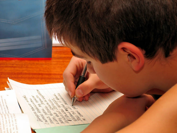 Boy writing at desk